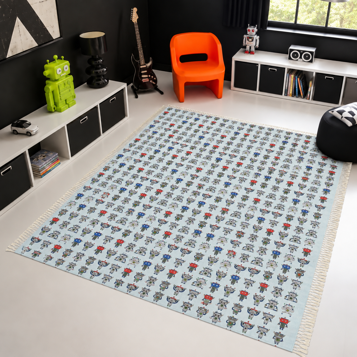 A large rectangular area rug with a light blue background and an all-over repeating pattern of small cartoon robots in red, blue, gray, and black, shown in a modern styled room with a white floor, black walls, and colorful decor.
