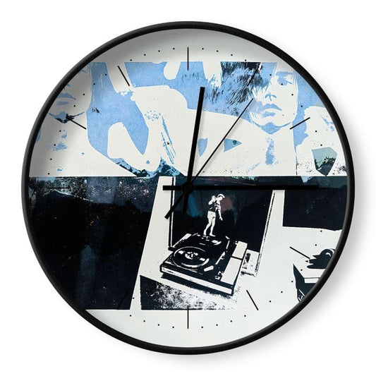 Wall clock with artistic design featuring people and a turntable.